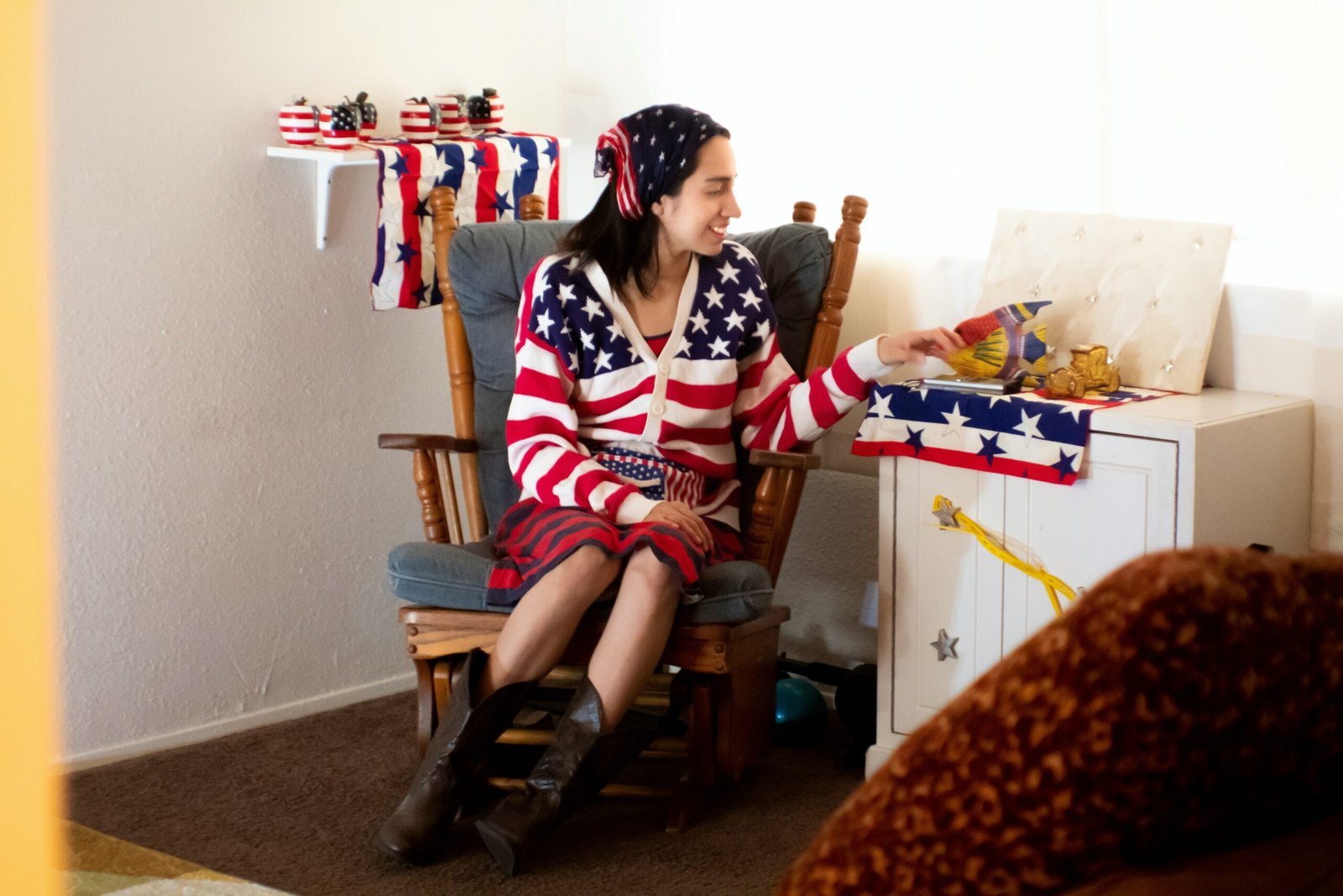 woman in black and white long sleeve shirt sitting on brown wooden armchair